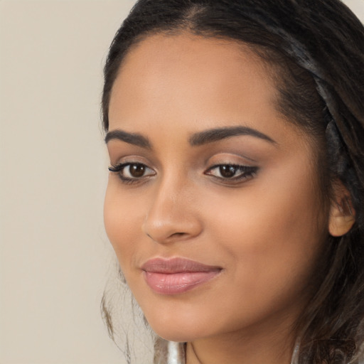 Joyful latino young-adult female with long  brown hair and brown eyes