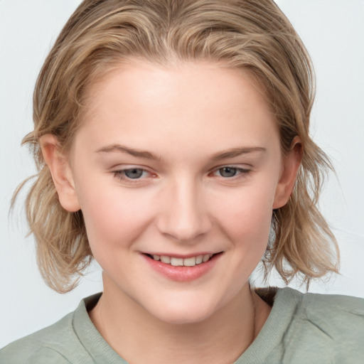 Joyful white young-adult female with medium  brown hair and blue eyes