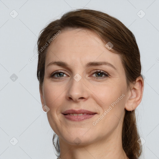 Joyful white adult female with medium  brown hair and grey eyes