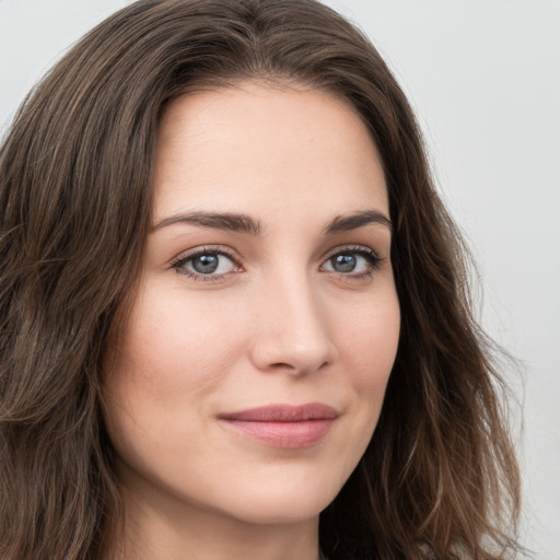 Joyful white young-adult female with long  brown hair and green eyes