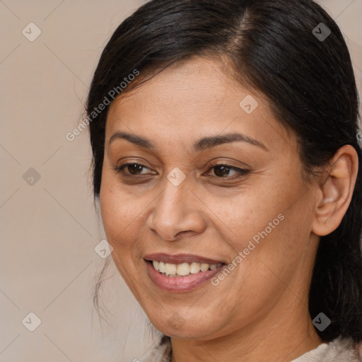 Joyful white adult female with medium  brown hair and brown eyes