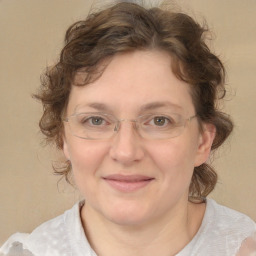 Joyful white adult female with medium  brown hair and blue eyes