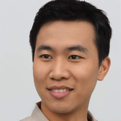 Joyful asian young-adult male with short  black hair and brown eyes
