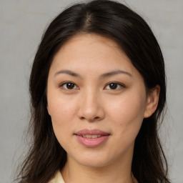 Joyful asian young-adult female with long  brown hair and brown eyes