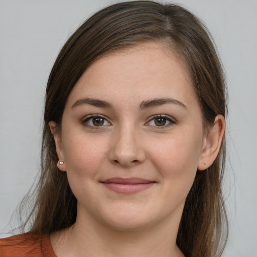 Joyful white young-adult female with long  brown hair and grey eyes