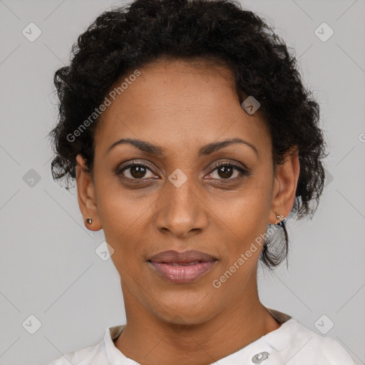 Joyful black adult female with short  black hair and brown eyes