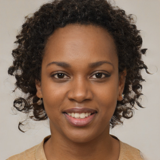 Joyful black young-adult female with medium  brown hair and brown eyes