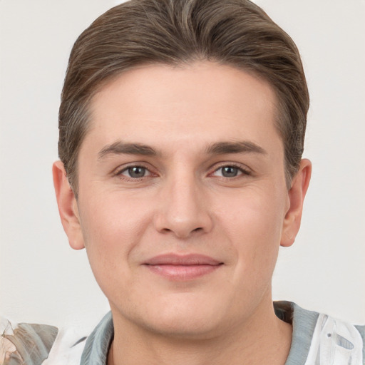 Joyful white young-adult male with short  brown hair and brown eyes