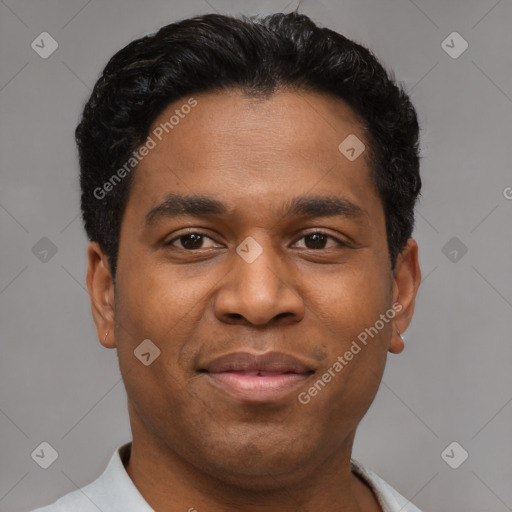 Joyful black young-adult male with short  brown hair and brown eyes
