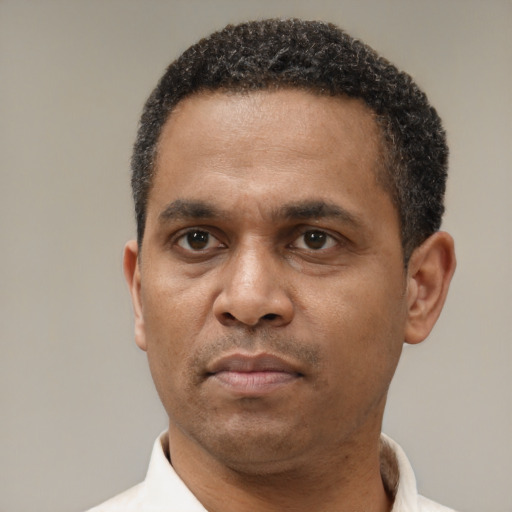 Neutral latino adult male with short  black hair and brown eyes