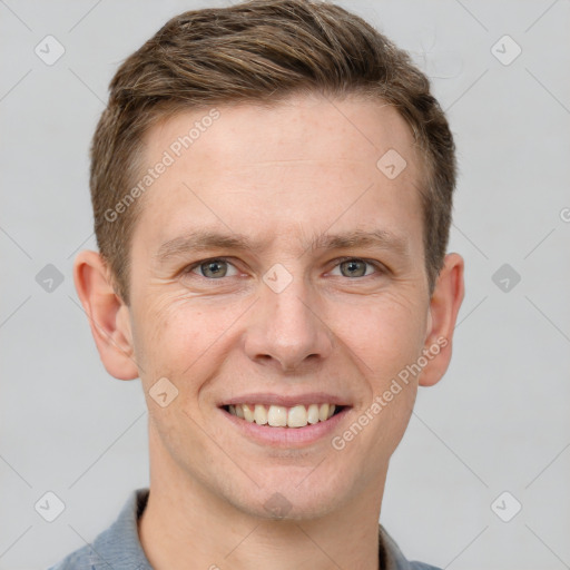 Joyful white young-adult male with short  brown hair and grey eyes