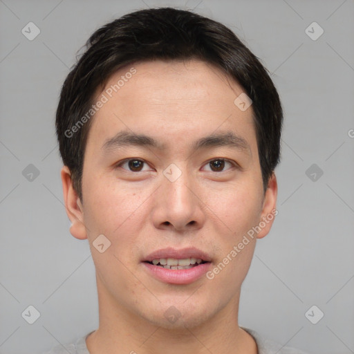 Joyful asian young-adult male with short  brown hair and brown eyes