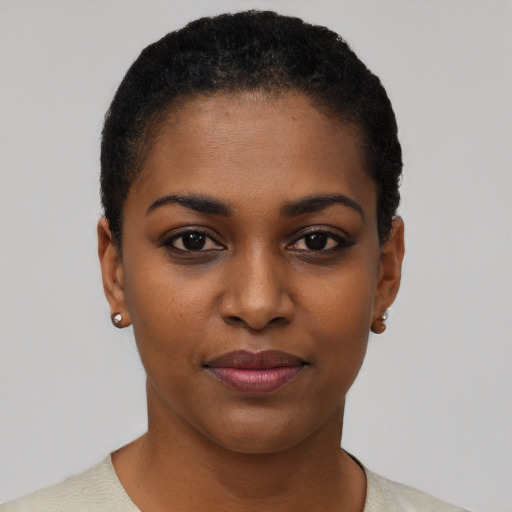 Joyful black young-adult female with short  black hair and brown eyes