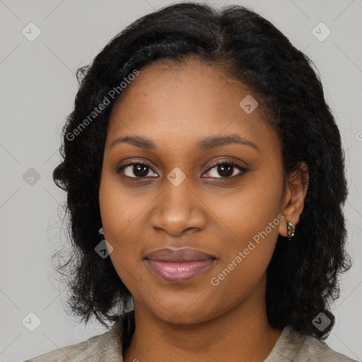 Joyful black young-adult female with long  black hair and brown eyes