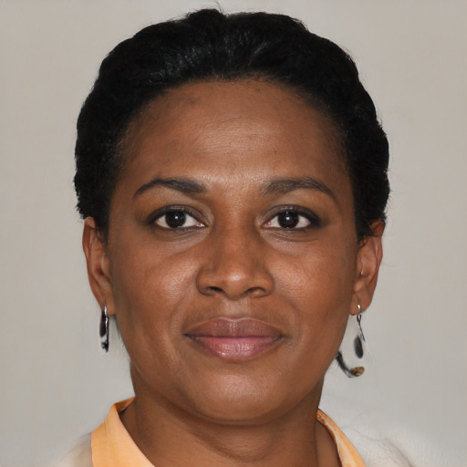 Joyful latino adult female with short  brown hair and brown eyes