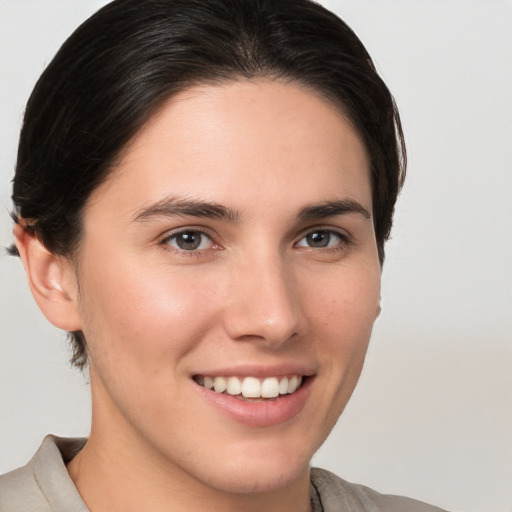 Joyful white young-adult female with medium  brown hair and brown eyes