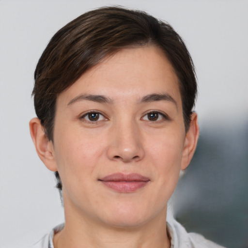 Joyful white young-adult female with short  brown hair and brown eyes