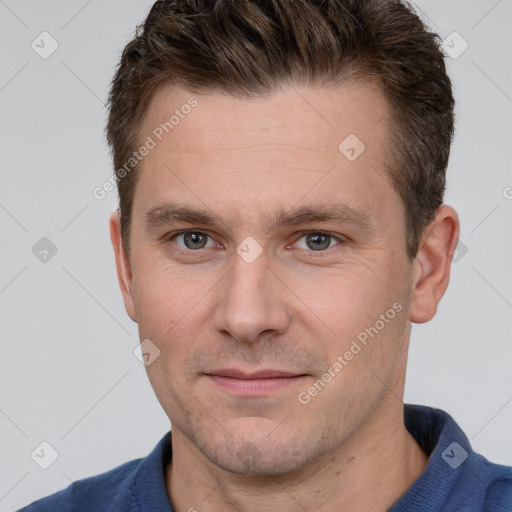 Joyful white adult male with short  brown hair and grey eyes