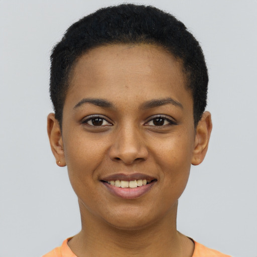 Joyful black young-adult female with short  black hair and brown eyes