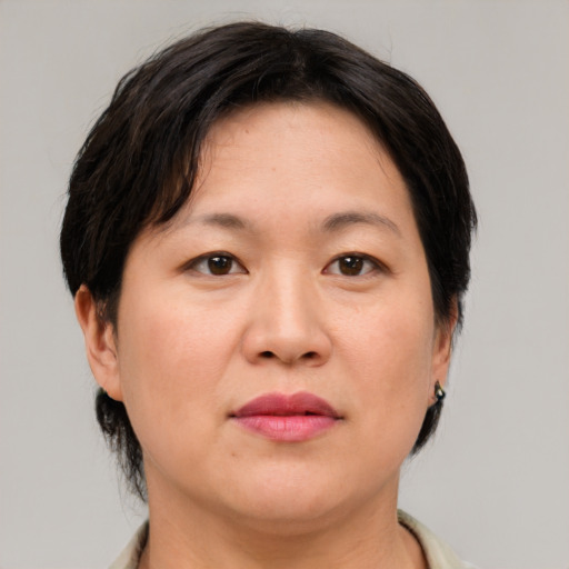 Neutral asian adult female with medium  brown hair and brown eyes