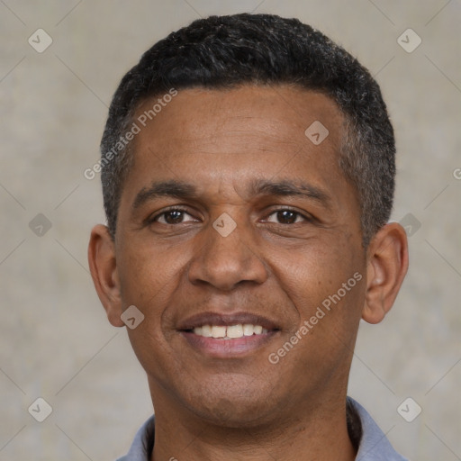 Joyful black adult male with short  black hair and brown eyes