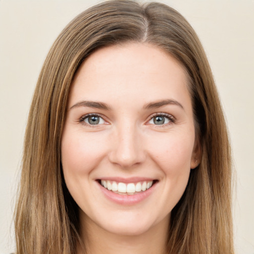 Joyful white young-adult female with long  brown hair and green eyes