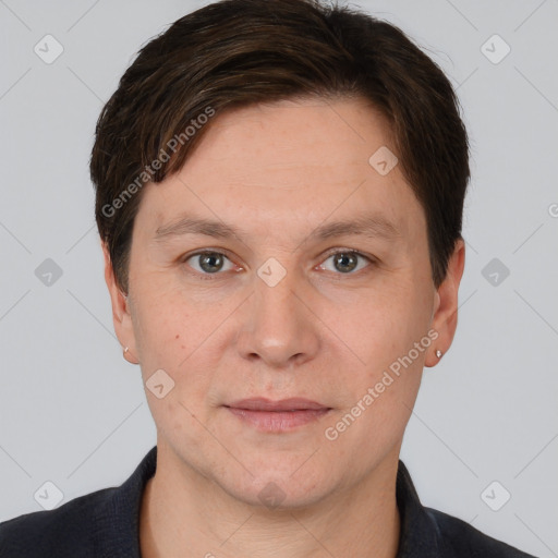 Joyful white adult male with short  brown hair and brown eyes