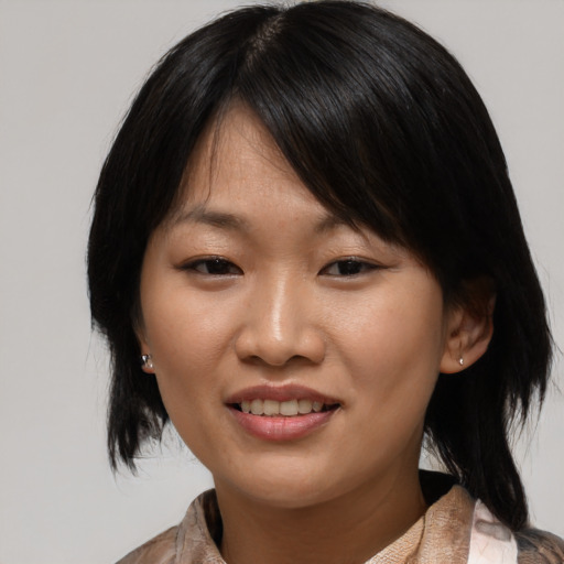 Joyful asian young-adult female with medium  black hair and brown eyes