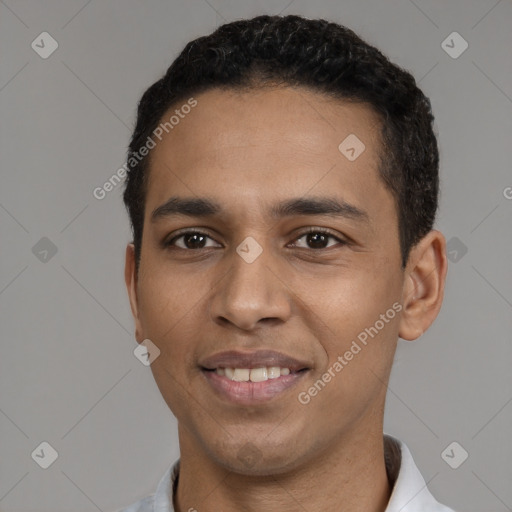 Joyful latino young-adult male with short  black hair and brown eyes