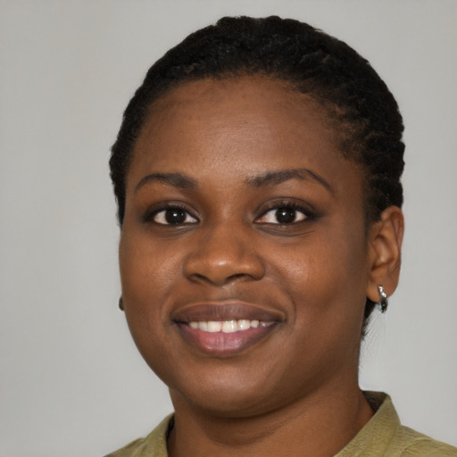 Joyful black young-adult female with short  black hair and brown eyes