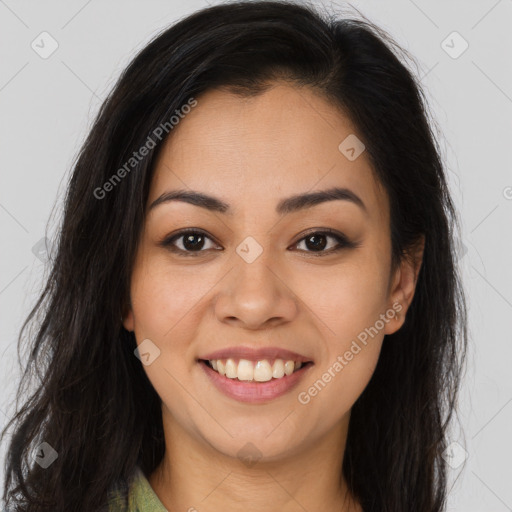 Joyful latino young-adult female with long  brown hair and brown eyes