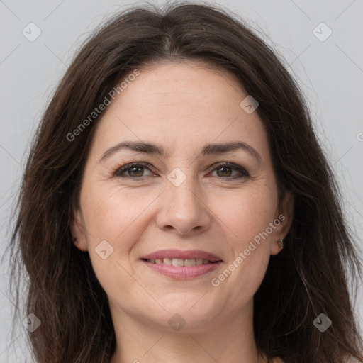 Joyful white adult female with long  brown hair and brown eyes