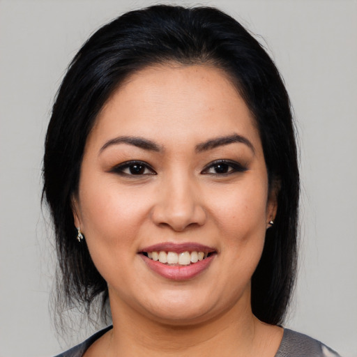 Joyful latino young-adult female with medium  black hair and brown eyes