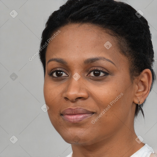 Joyful black young-adult female with short  black hair and brown eyes