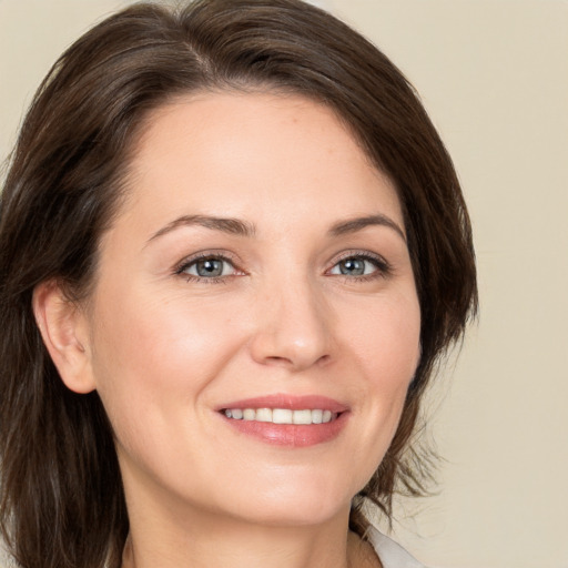 Joyful white young-adult female with medium  brown hair and brown eyes