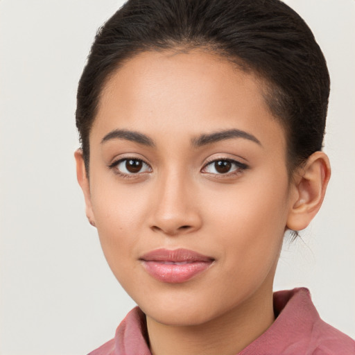 Joyful latino young-adult female with long  brown hair and brown eyes