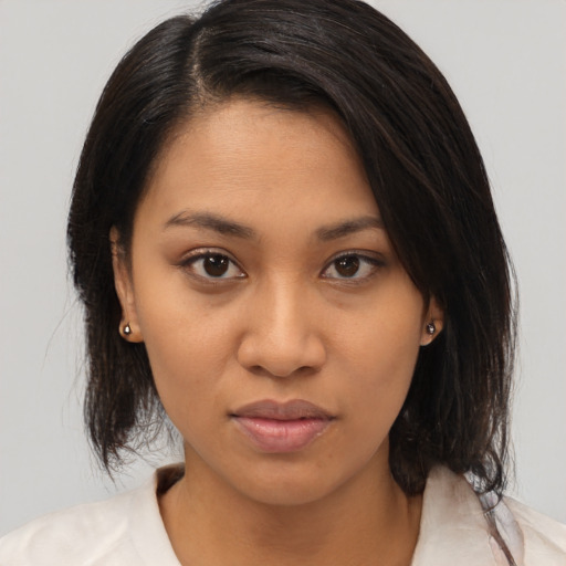 Neutral black young-adult female with medium  brown hair and brown eyes