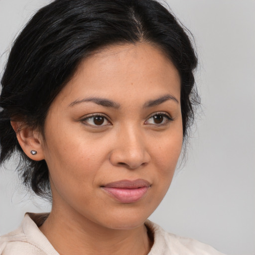 Joyful latino young-adult female with medium  brown hair and brown eyes
