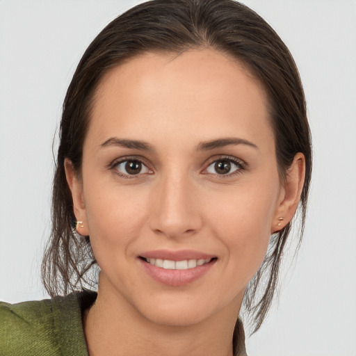 Joyful white young-adult female with medium  brown hair and brown eyes