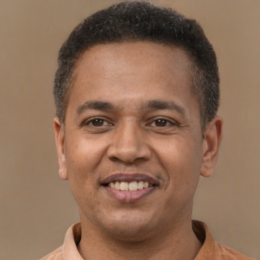 Joyful latino adult male with short  brown hair and brown eyes