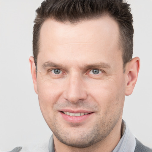 Joyful white adult male with short  brown hair and brown eyes