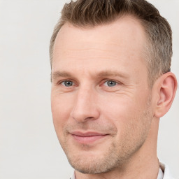 Joyful white adult male with short  brown hair and grey eyes