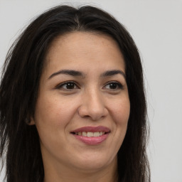 Joyful white adult female with long  brown hair and brown eyes