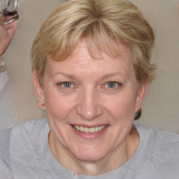 Joyful white adult female with medium  brown hair and blue eyes