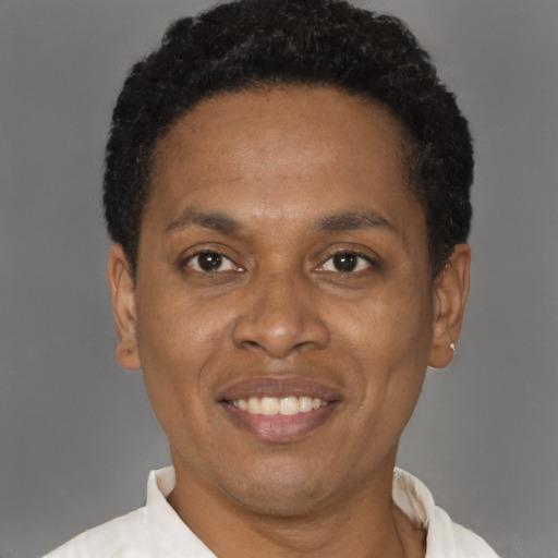 Joyful black adult male with short  brown hair and brown eyes