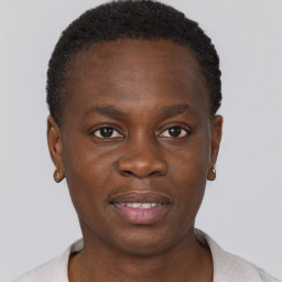 Joyful black young-adult male with short  brown hair and brown eyes