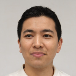 Joyful asian young-adult male with short  black hair and brown eyes