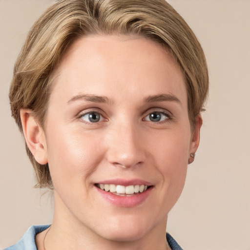 Joyful white young-adult female with short  brown hair and blue eyes