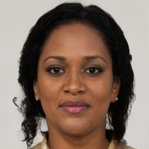 Joyful black adult female with medium  brown hair and brown eyes