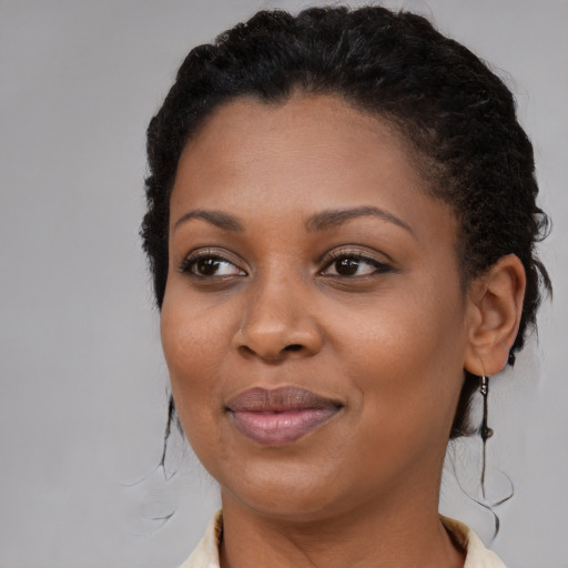 Joyful black young-adult female with medium  brown hair and brown eyes